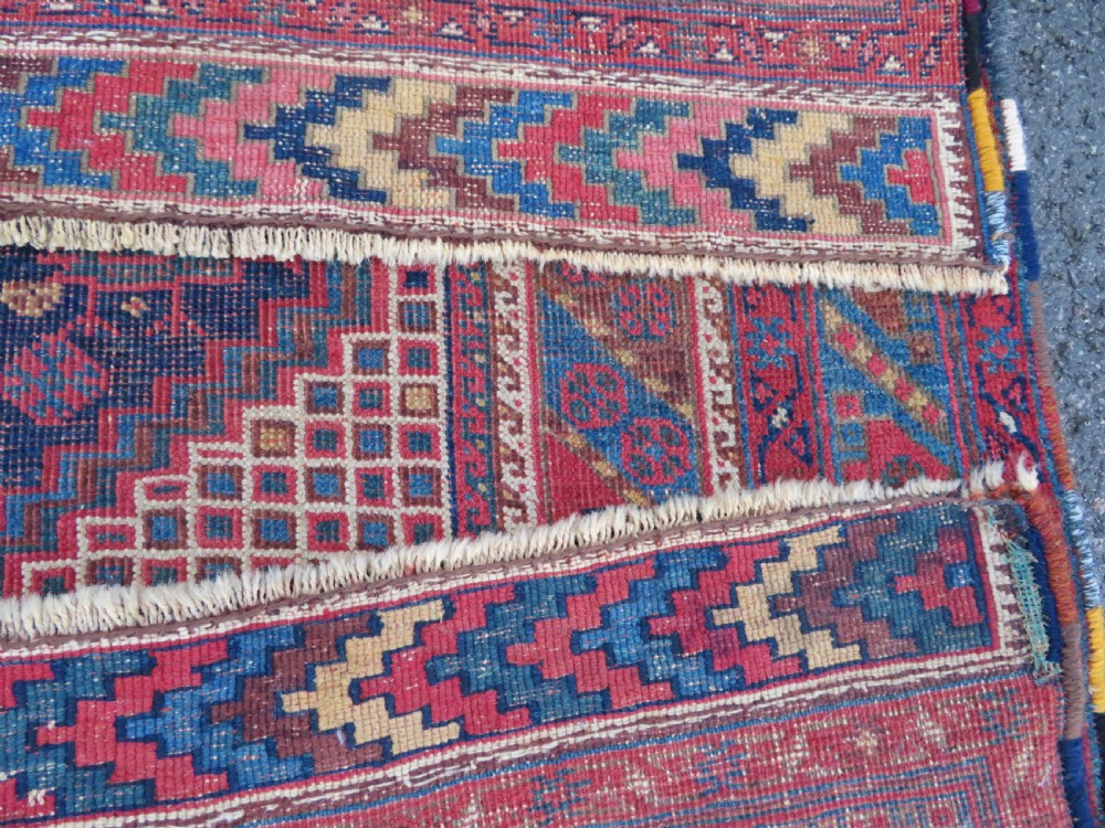 An antique Khamseh hand-knotted wool rug featuring five central diamond medallions on a dark navy and red field decorated with tribal bird motifs. View XXII
