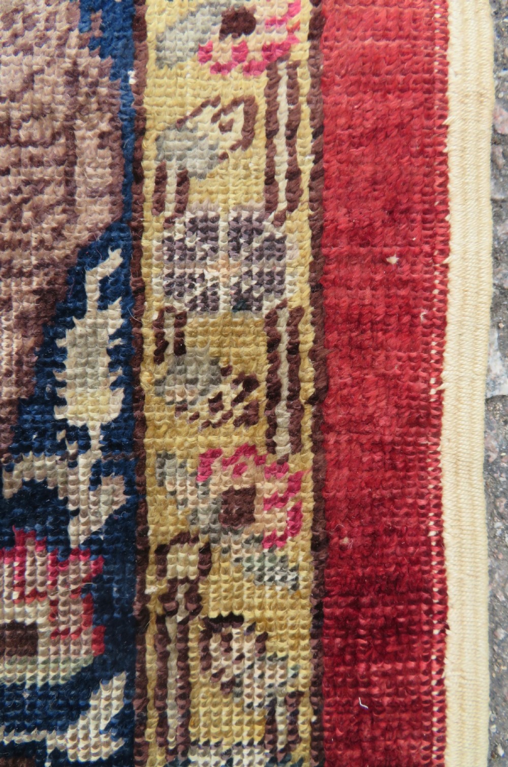 A 19th-century West Anatolian silk rug featuring a red central panel depicting horseback hunters, surrounded by a floral and animal motif navy border. View IX