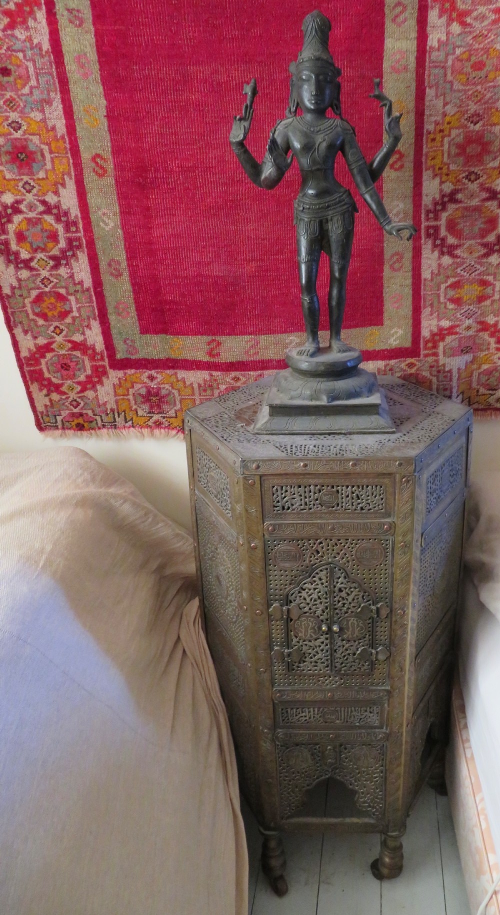 A hexagonal antique brass occasional table with pierced openwork panels, Arabic calligraphic inlays in copper and white metal, and double cabinet doors. View II