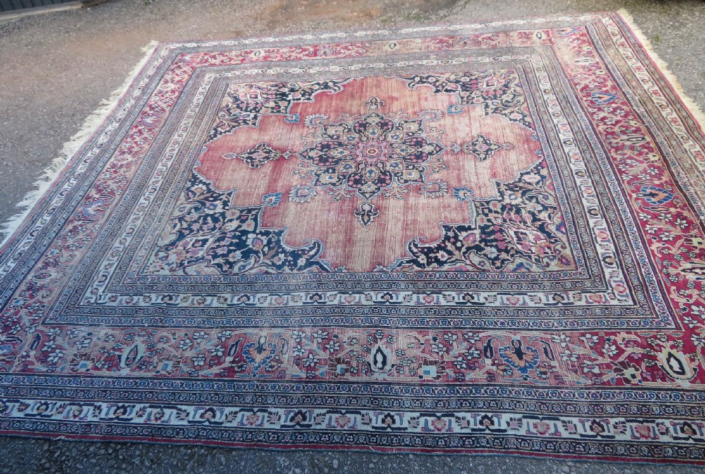 An antique hand-knotted Meshed Persian wool carpet featuring a central navy blue medallion on a distressed rose pink field surrounded by intricate floral borders. View II