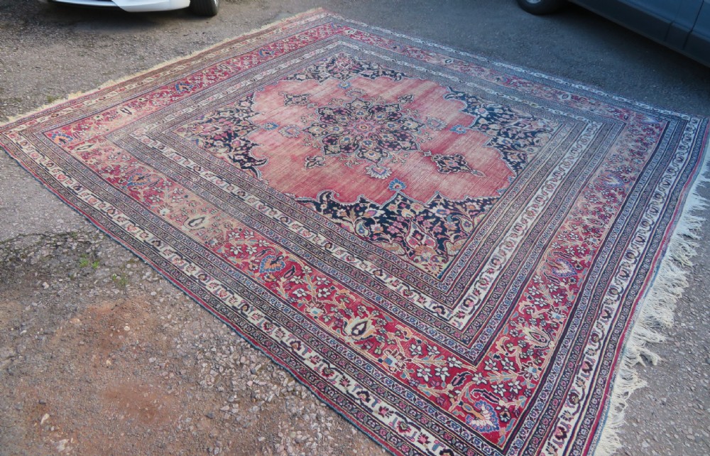 An antique hand-knotted Meshed Persian wool carpet featuring a central navy blue medallion on a distressed rose pink field surrounded by intricate floral borders. View III