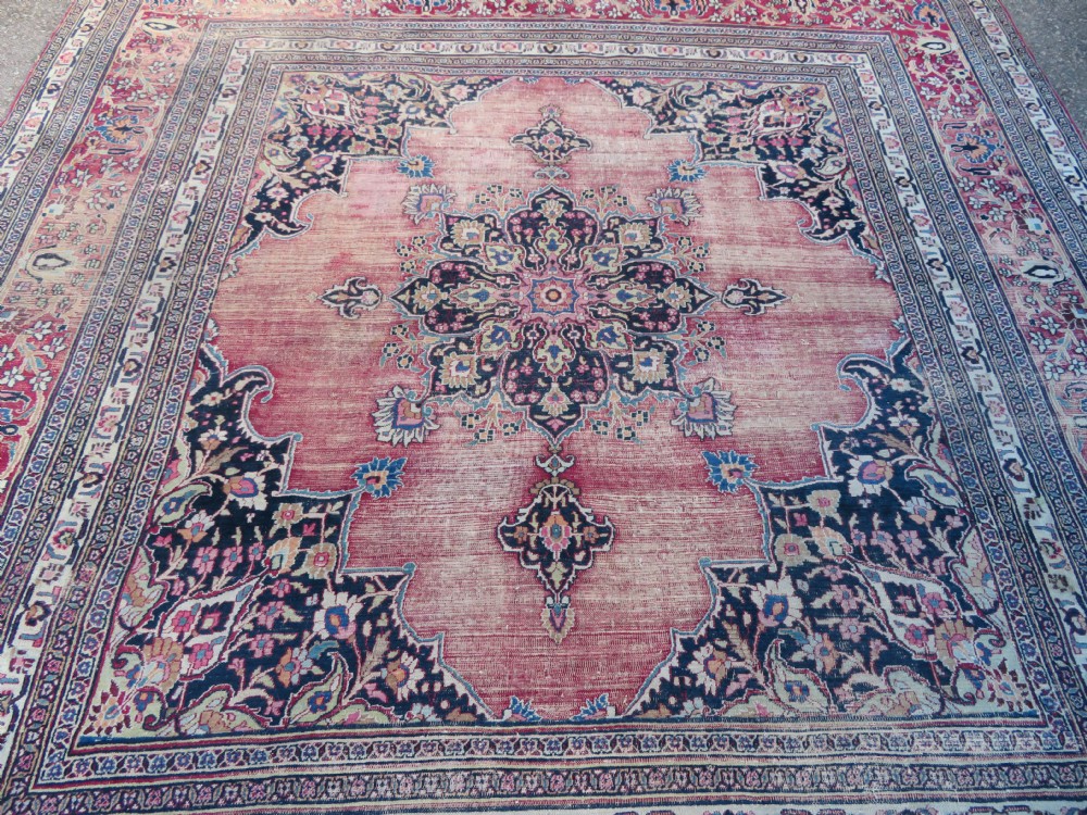 An antique hand-knotted Meshed Persian wool carpet featuring a central navy blue medallion on a distressed rose pink field surrounded by intricate floral borders. View IV