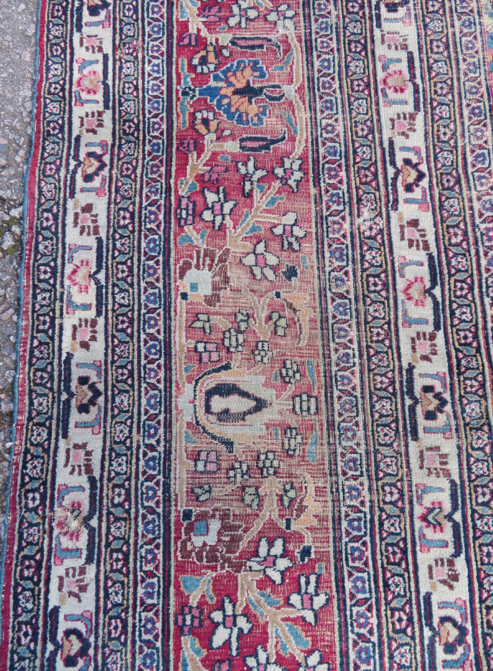 An antique hand-knotted Meshed Persian wool carpet featuring a central navy blue medallion on a distressed rose pink field surrounded by intricate floral borders. View IX