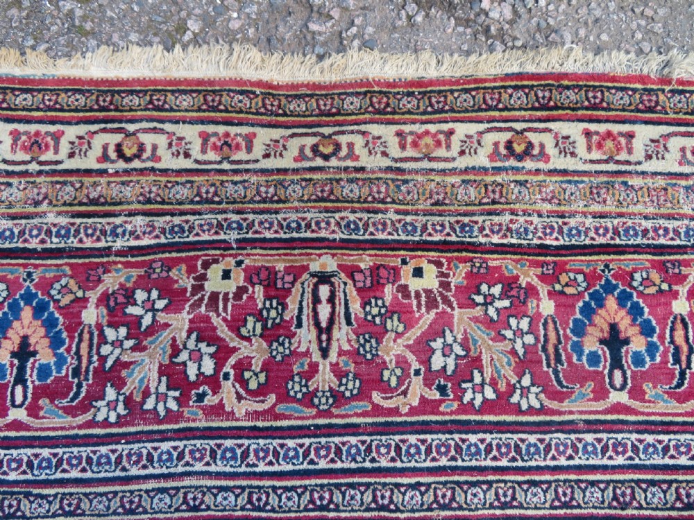 An antique hand-knotted Meshed Persian wool carpet featuring a central navy blue medallion on a distressed rose pink field surrounded by intricate floral borders. View XI