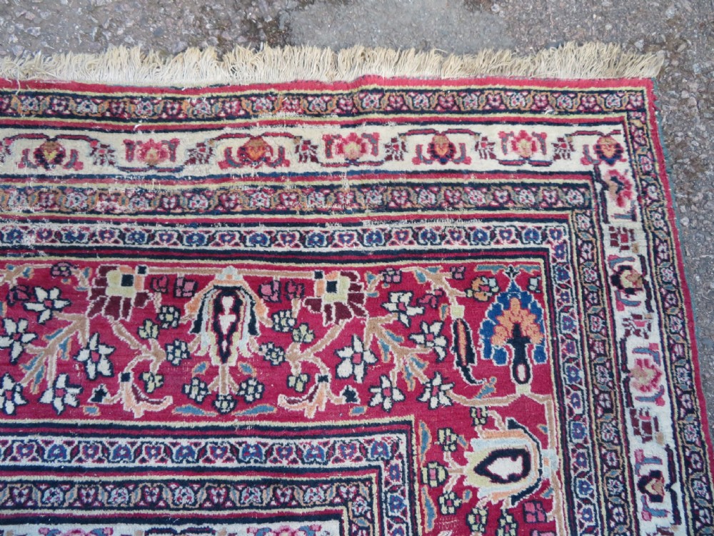An antique hand-knotted Meshed Persian wool carpet featuring a central navy blue medallion on a distressed rose pink field surrounded by intricate floral borders. View XII
