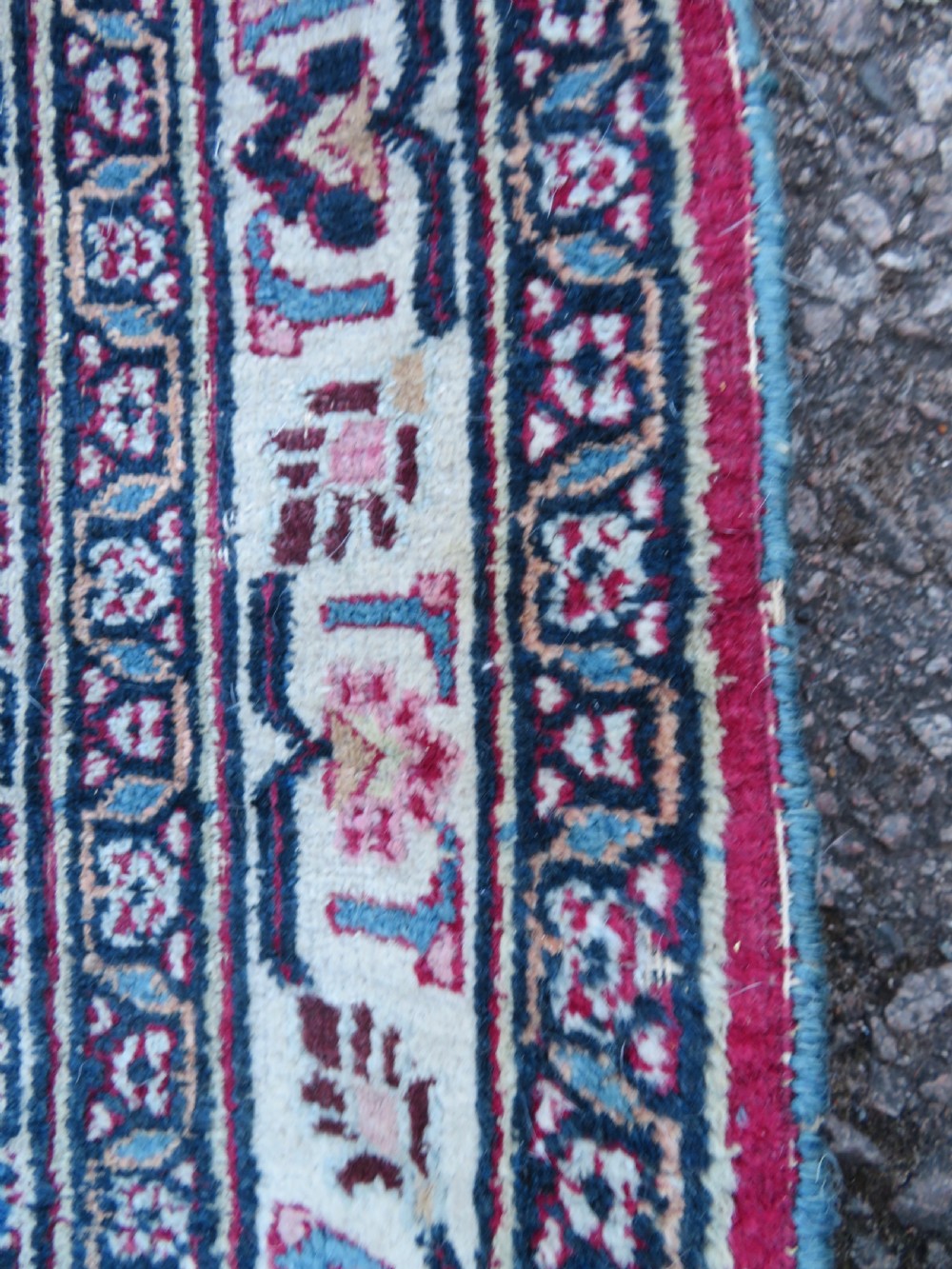 An antique hand-knotted Meshed Persian wool carpet featuring a central navy blue medallion on a distressed rose pink field surrounded by intricate floral borders. View XVI