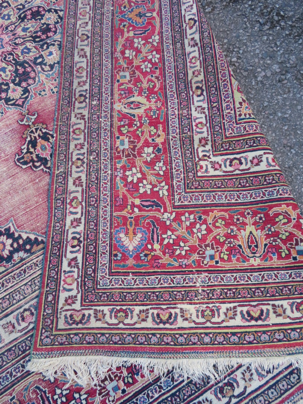 An antique hand-knotted Meshed Persian wool carpet featuring a central navy blue medallion on a distressed rose pink field surrounded by intricate floral borders. View XVII