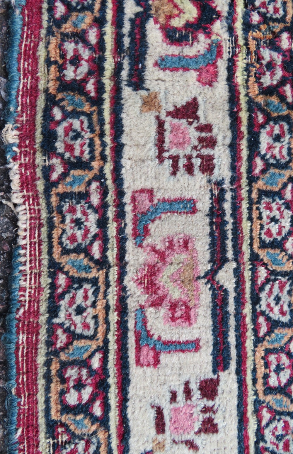 An antique hand-knotted Meshed Persian wool carpet featuring a central navy blue medallion on a distressed rose pink field surrounded by intricate floral borders. View XX