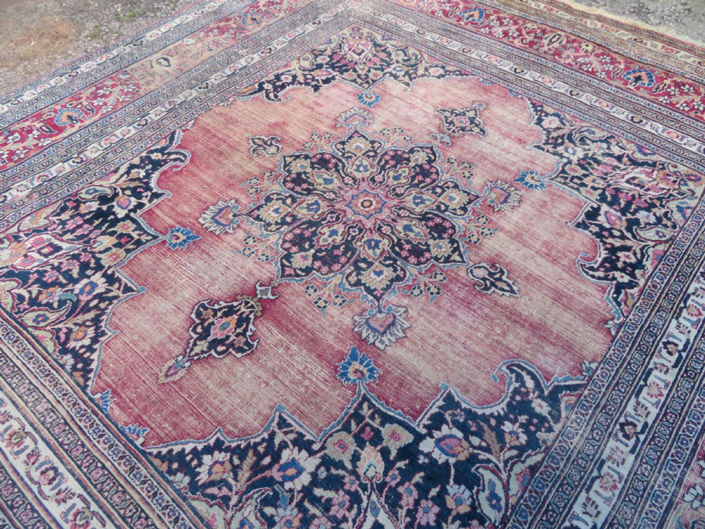 An antique hand-knotted Meshed Persian wool carpet featuring a central navy blue medallion on a distressed rose pink field surrounded by intricate floral borders. View XXII