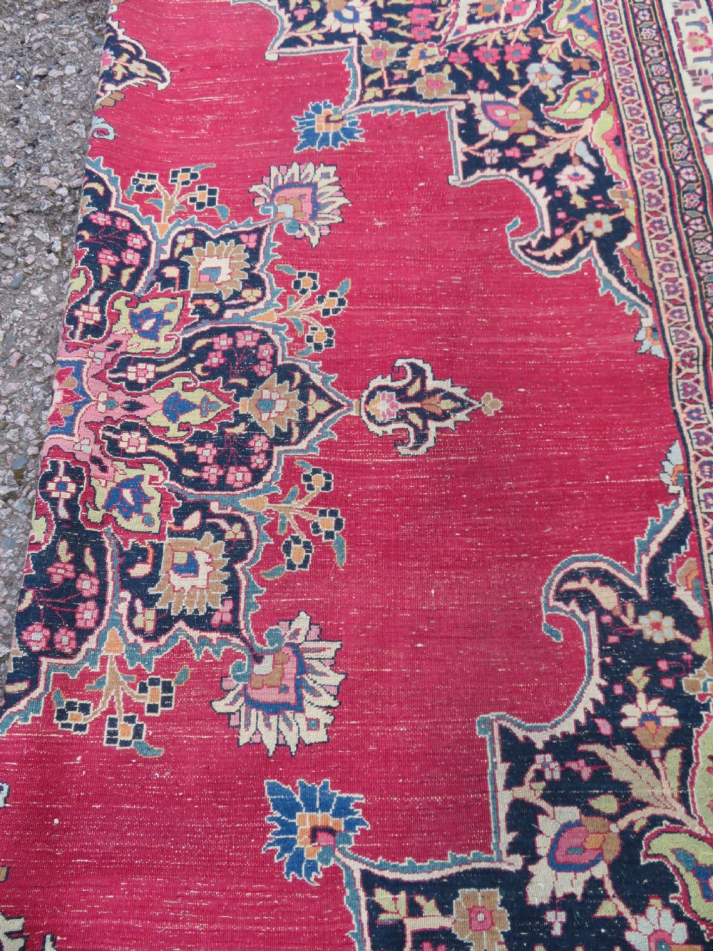 An antique hand-knotted Meshed Persian wool carpet featuring a central navy blue medallion on a distressed rose pink field surrounded by intricate floral borders. View XXV