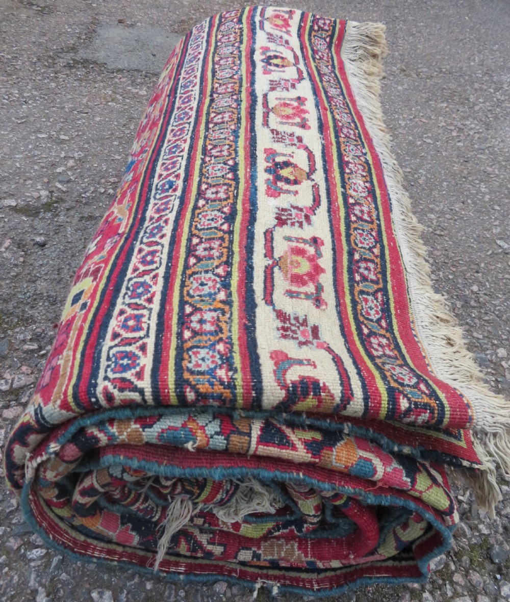 An antique hand-knotted Meshed Persian wool carpet featuring a central navy blue medallion on a distressed rose pink field surrounded by intricate floral borders. View XXVI