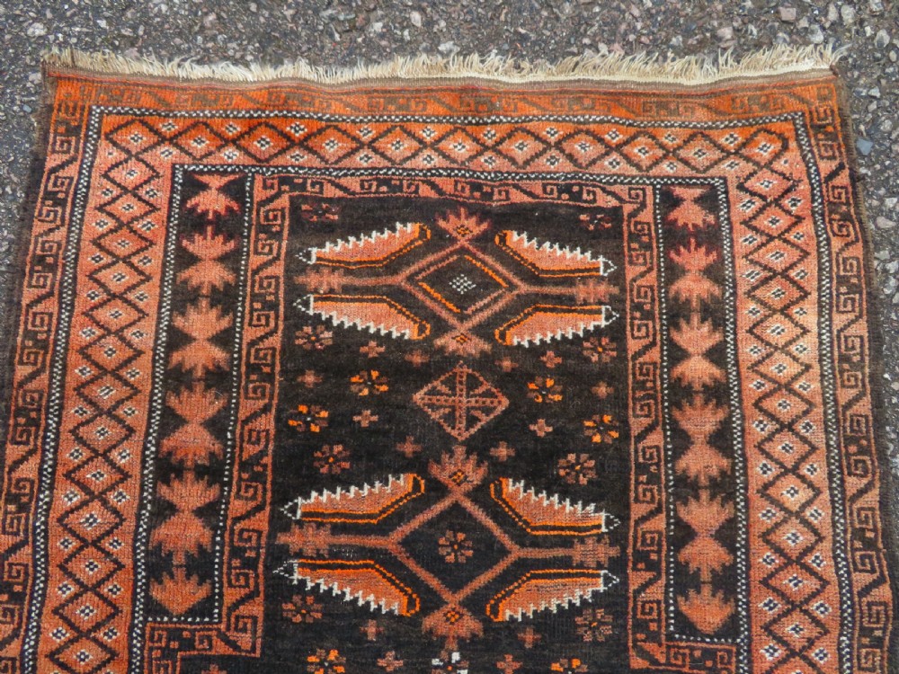 A hand-woven wool Afghan prayer rug featuring a dark brown central field with terracotta geometric motifs and a distinct pointed arch design. View II