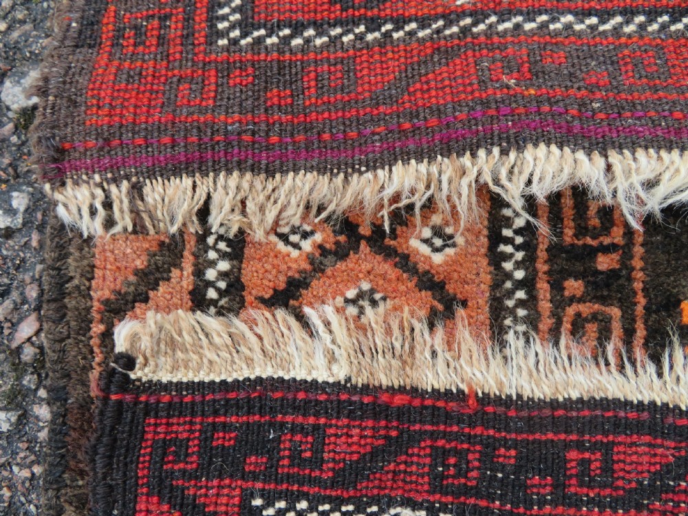 A hand-woven wool Afghan prayer rug featuring a dark brown central field with terracotta geometric motifs and a distinct pointed arch design. View IX