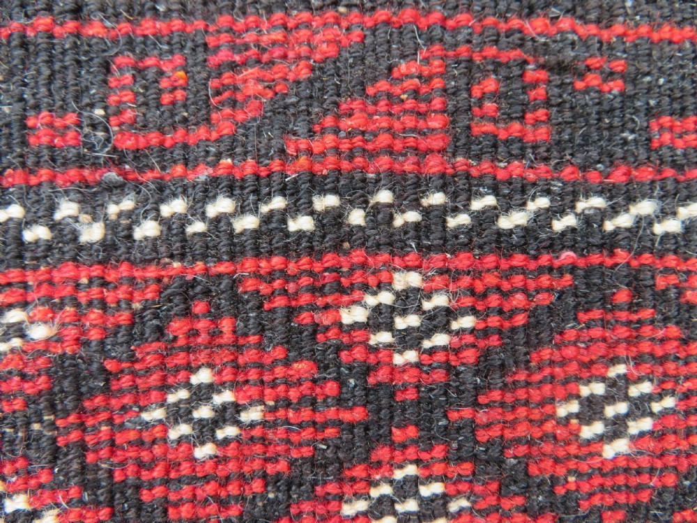A hand-woven wool Afghan prayer rug featuring a dark brown central field with terracotta geometric motifs and a distinct pointed arch design. View X