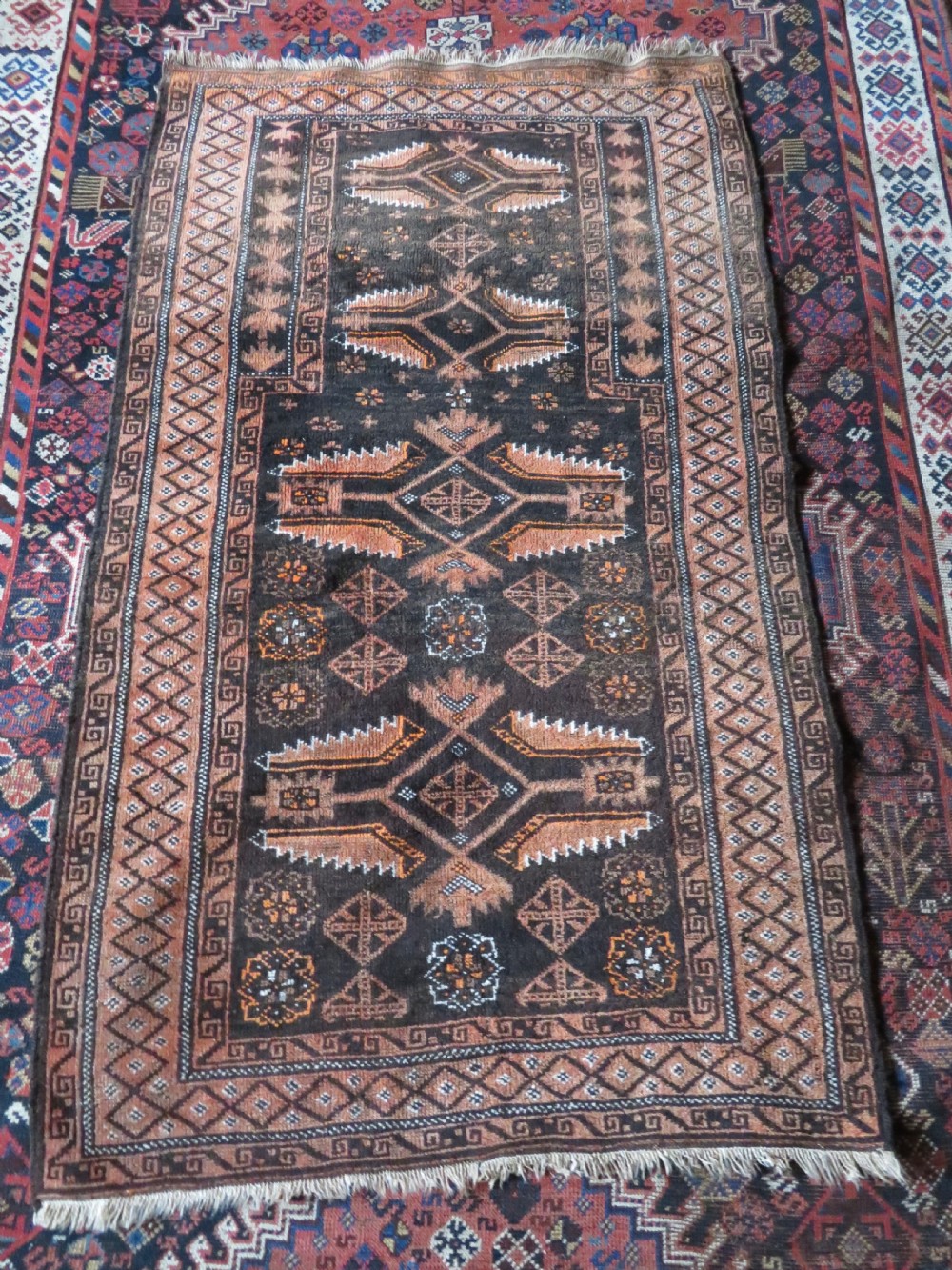 A hand-woven wool Afghan prayer rug featuring a dark brown central field with terracotta geometric motifs and a distinct pointed arch design. View XI