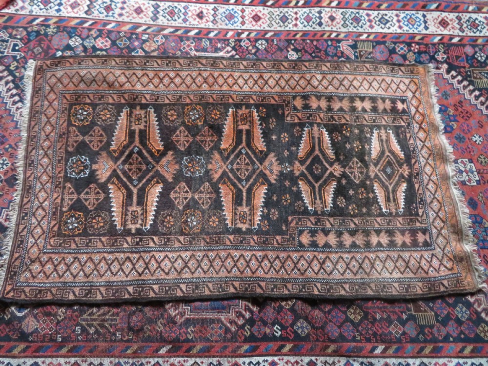 A hand-woven wool Afghan prayer rug featuring a dark brown central field with terracotta geometric motifs and a distinct pointed arch design. View XII
