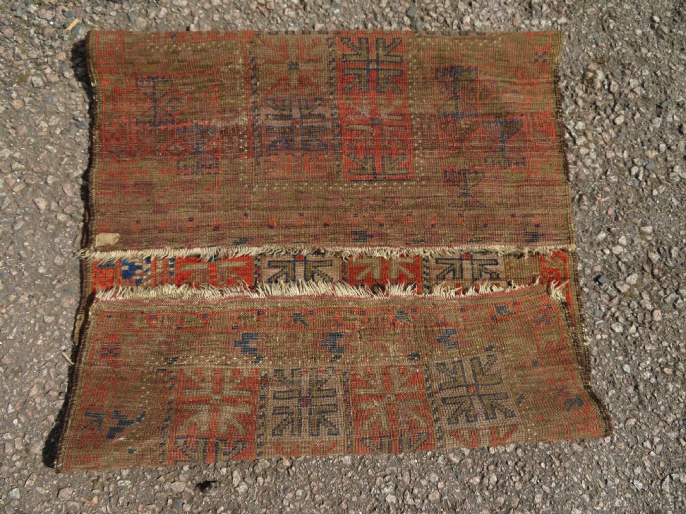 An antique hand-woven Baluch prayer rug showing distressed pile wear with geometric motifs in terracotta red, indigo, and deep brown. View VIII