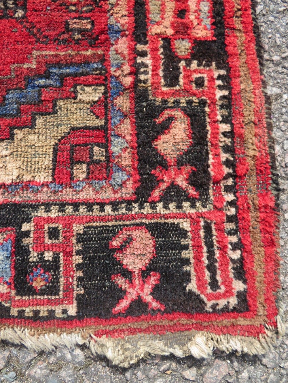 A rectangular distressed Persian Hamadan wool rug featuring a central stepped cross medallion on a crimson field with geometric borders. View V