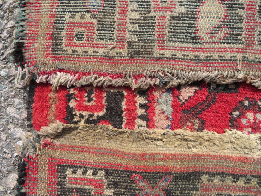 A rectangular distressed Persian Hamadan wool rug featuring a central stepped cross medallion on a crimson field with geometric borders. View XIII