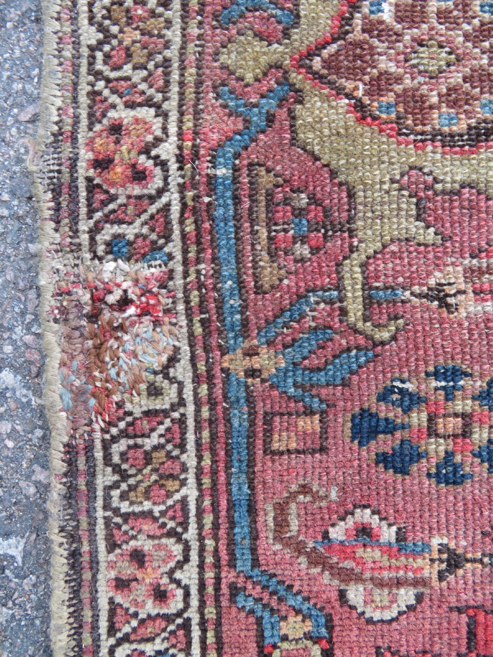 An antique hand-knotted North West Persian long rug featuring five geometric central medallions set against a dark field with a red pattern border. View V