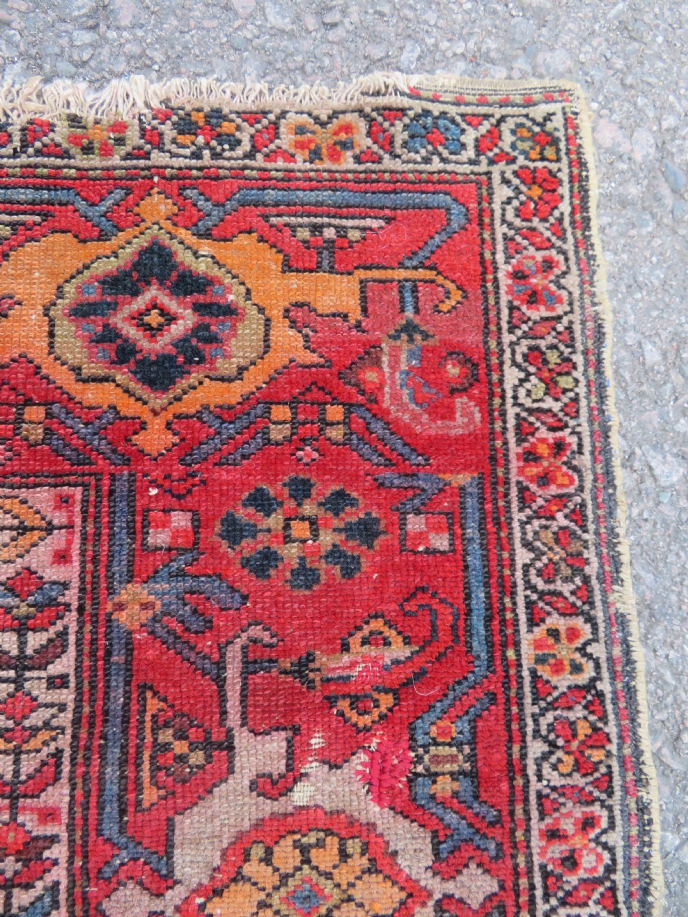 An antique hand-knotted North West Persian long rug featuring five geometric central medallions set against a dark field with a red pattern border. View IX