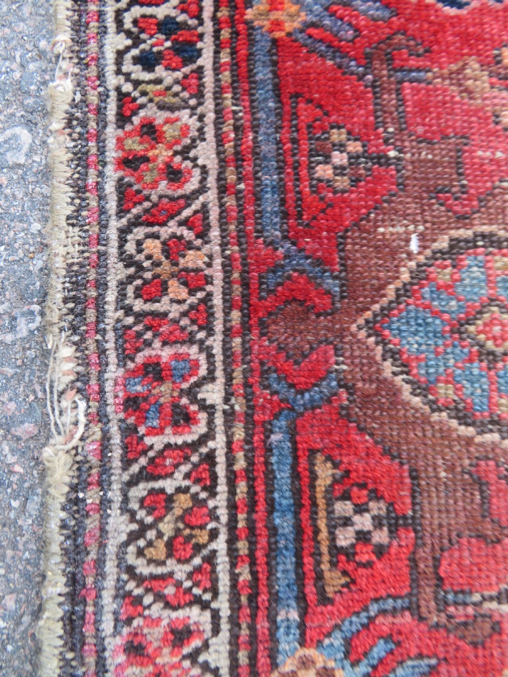 An antique hand-knotted North West Persian long rug featuring five geometric central medallions set against a dark field with a red pattern border. View X