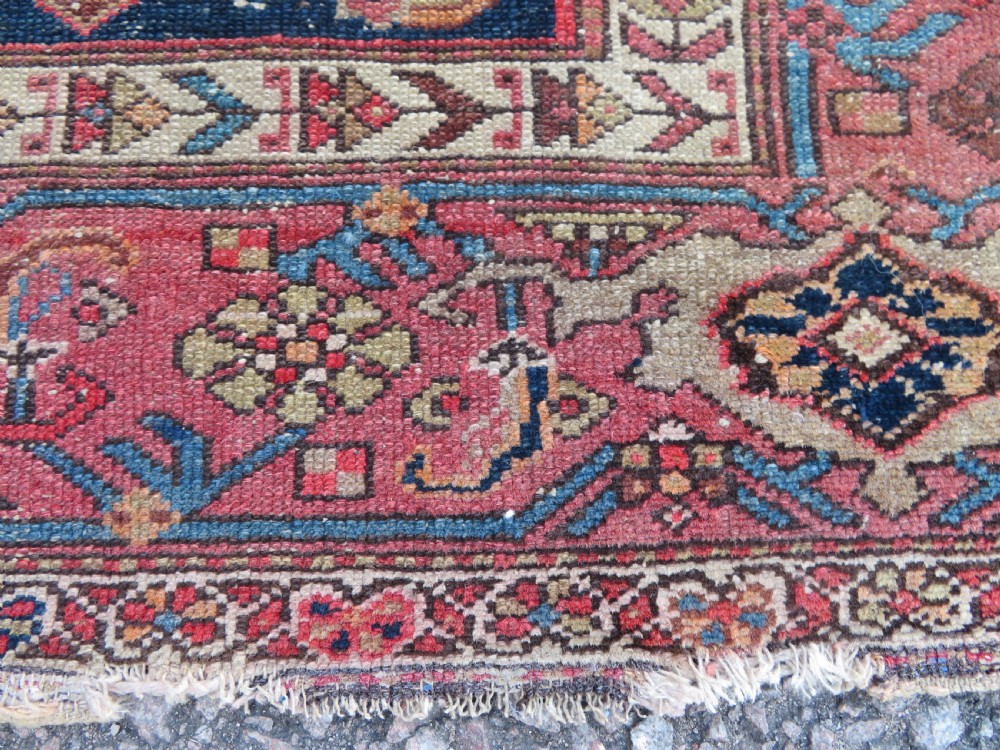 An antique hand-knotted North West Persian long rug featuring five geometric central medallions set against a dark field with a red pattern border. View XI