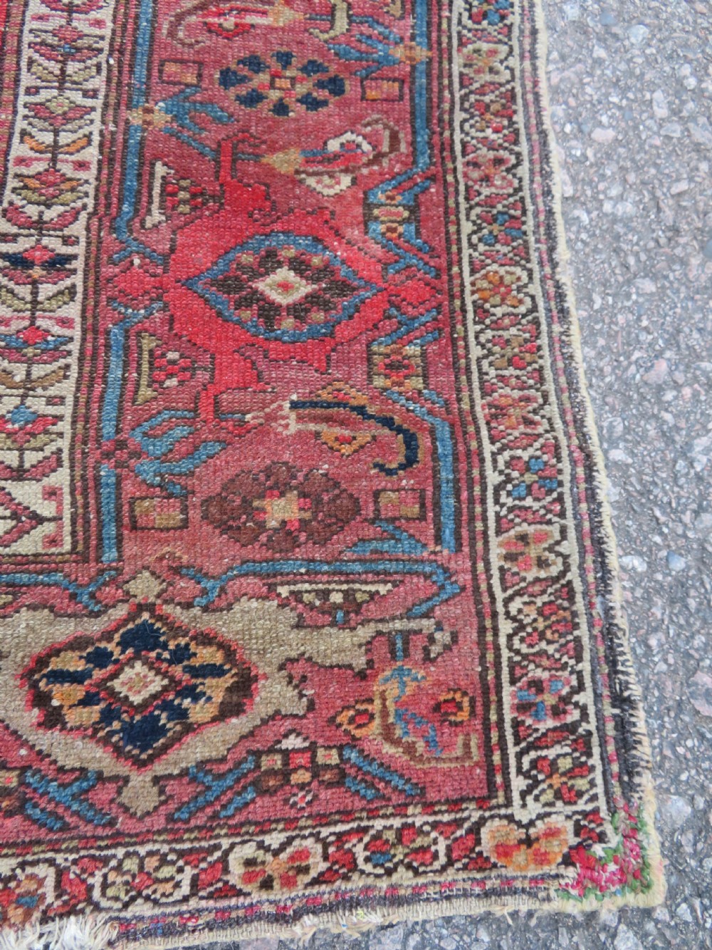 An antique hand-knotted North West Persian long rug featuring five geometric central medallions set against a dark field with a red pattern border. View XII