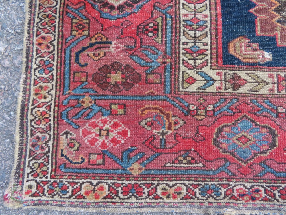 An antique hand-knotted North West Persian long rug featuring five geometric central medallions set against a dark field with a red pattern border. View XIII