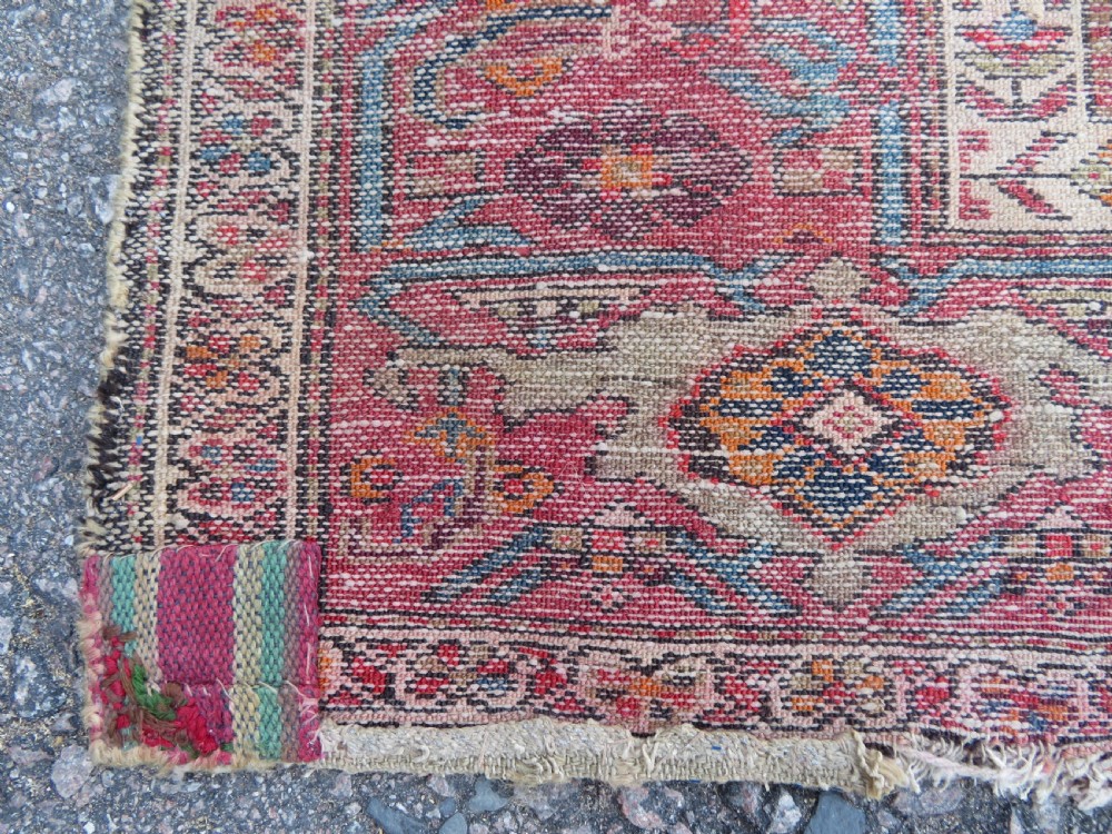 An antique hand-knotted North West Persian long rug featuring five geometric central medallions set against a dark field with a red pattern border. View XVI