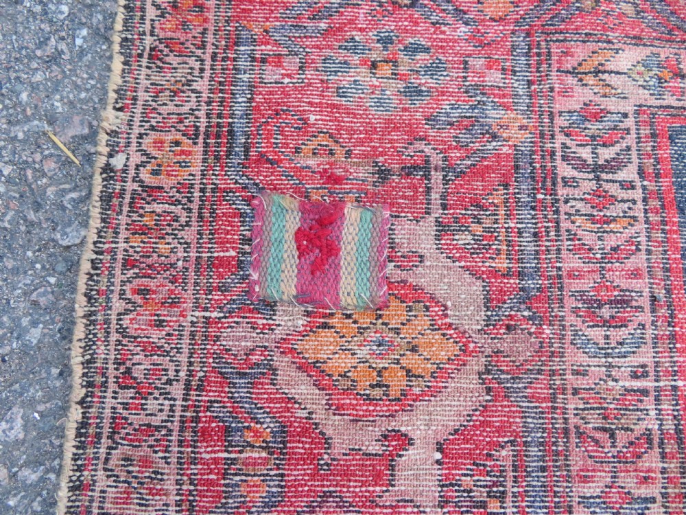 An antique hand-knotted North West Persian long rug featuring five geometric central medallions set against a dark field with a red pattern border. View XVII