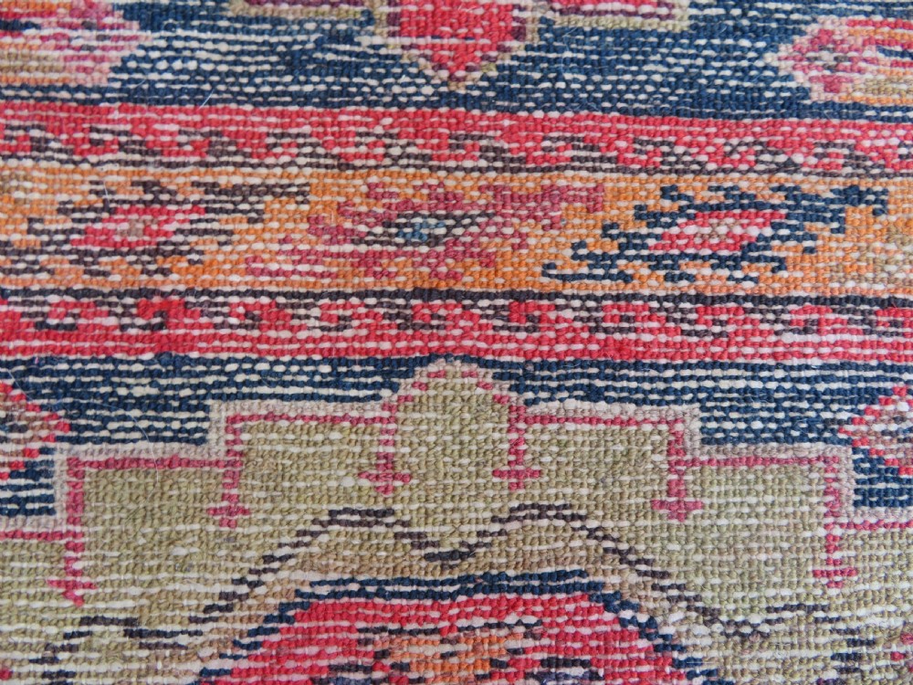 An antique hand-knotted North West Persian long rug featuring five geometric central medallions set against a dark field with a red pattern border. View XVIII