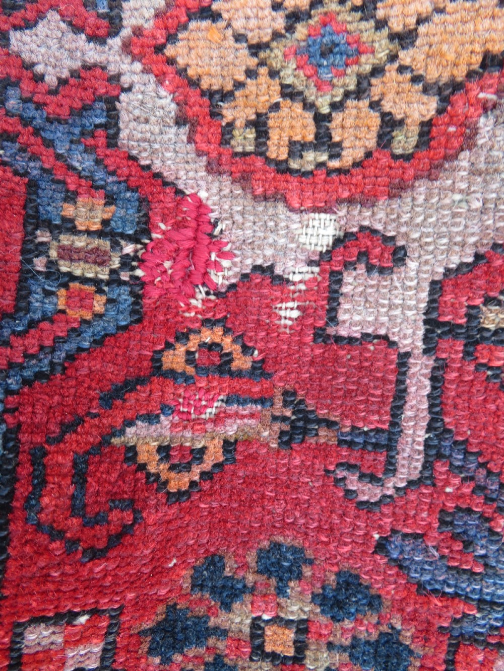 An antique hand-knotted North West Persian long rug featuring five geometric central medallions set against a dark field with a red pattern border. View XIX