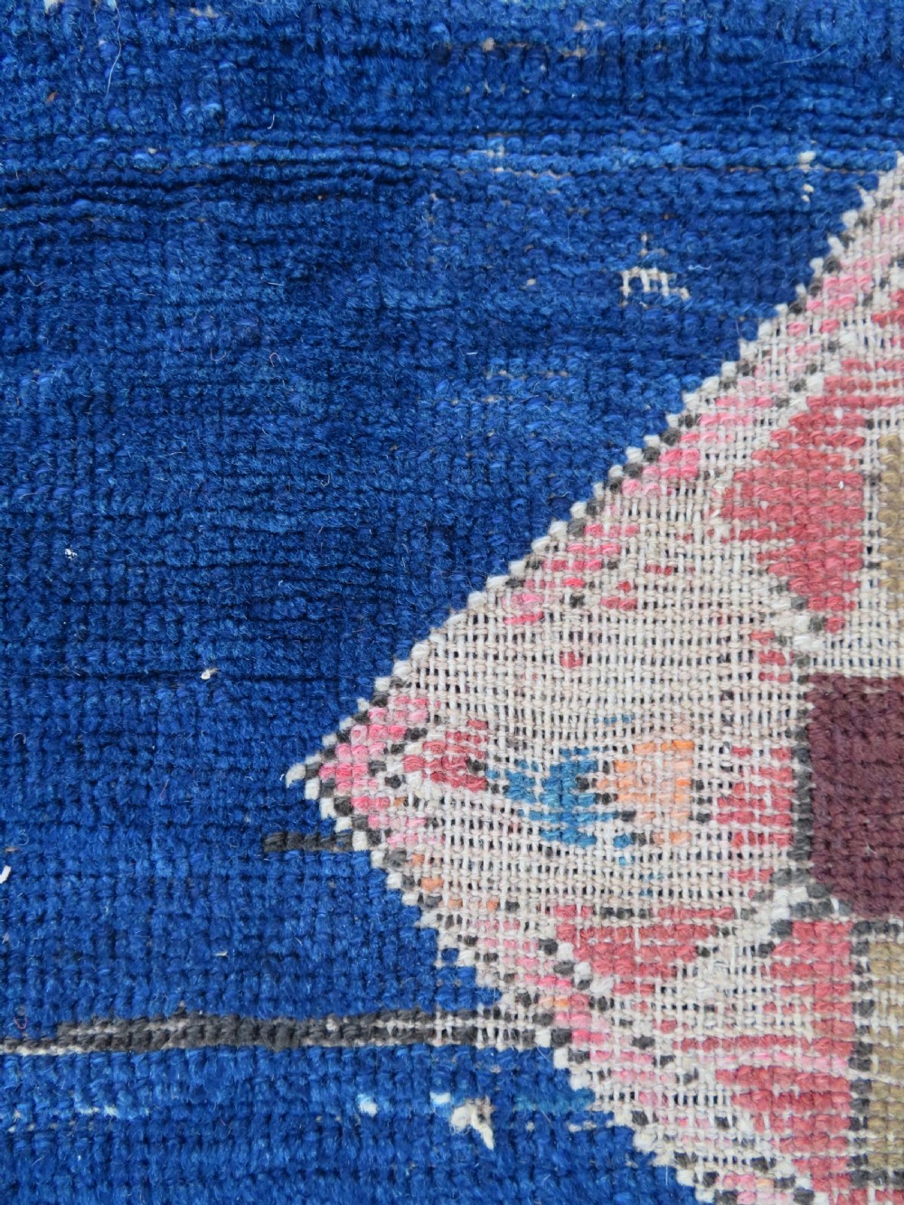 An antique hand-woven Turkish runner rug featuring indigo blue ends and a distressed red and cream geometric central medallion pattern. View VII