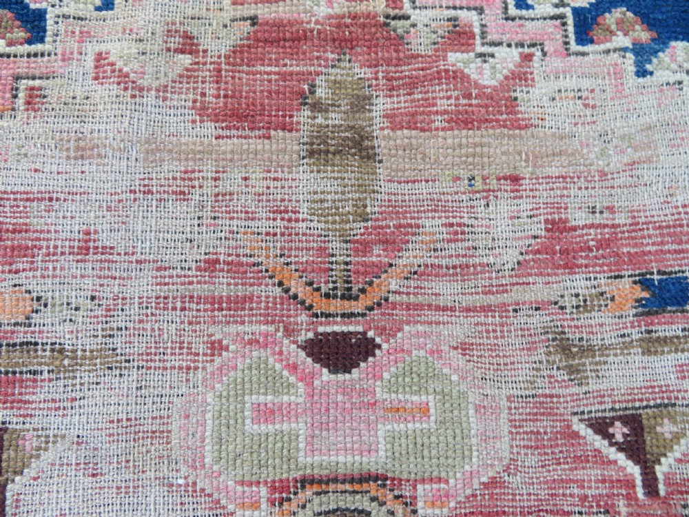An antique hand-woven Turkish runner rug featuring indigo blue ends and a distressed red and cream geometric central medallion pattern. View VIII