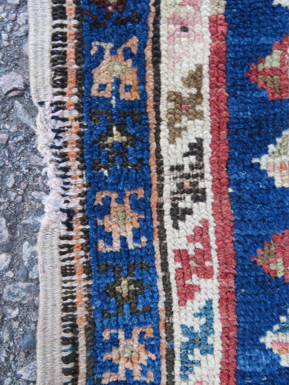 An antique hand-woven Turkish runner rug featuring indigo blue ends and a distressed red and cream geometric central medallion pattern. View XIV