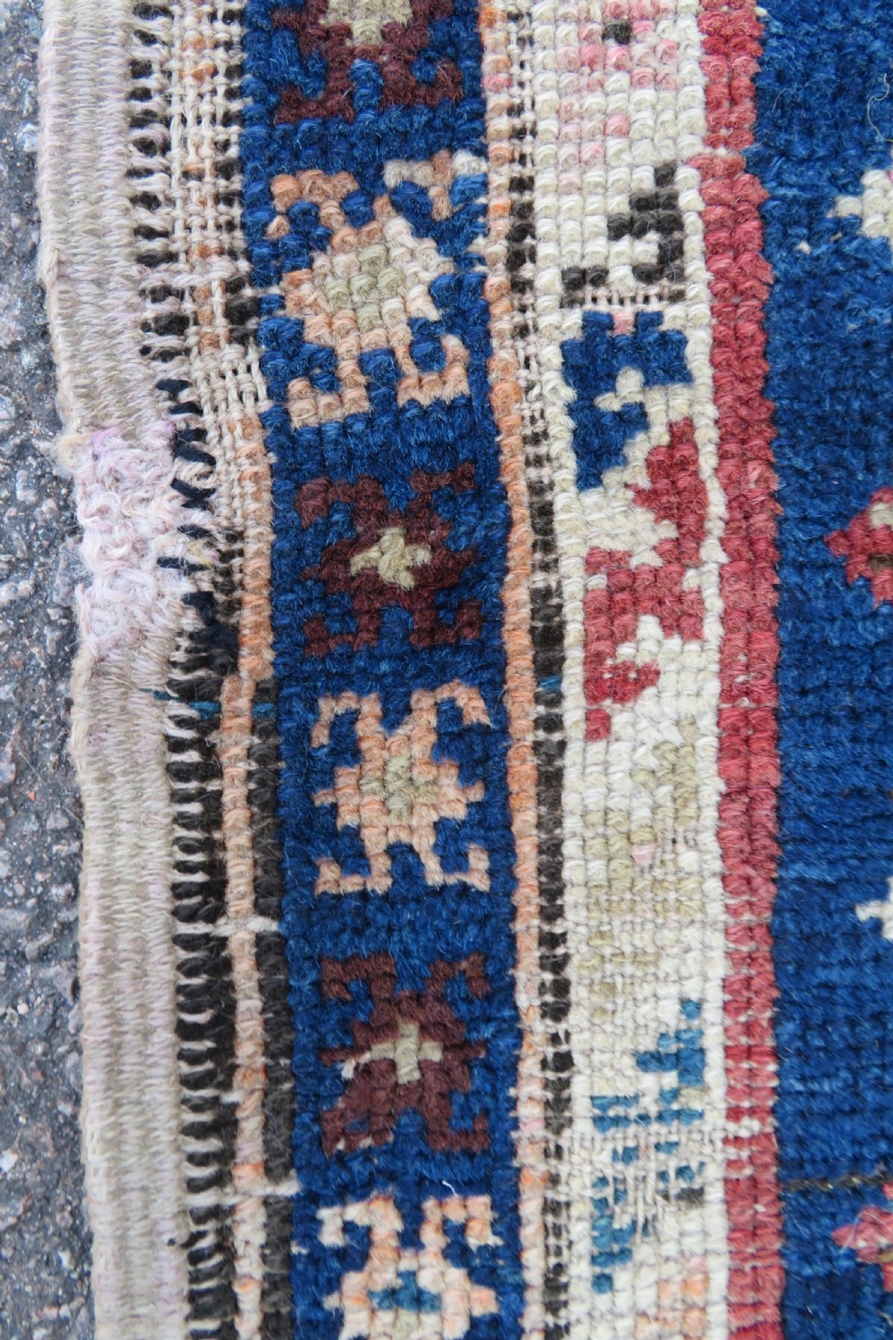 An antique hand-woven Turkish runner rug featuring indigo blue ends and a distressed red and cream geometric central medallion pattern. View XV