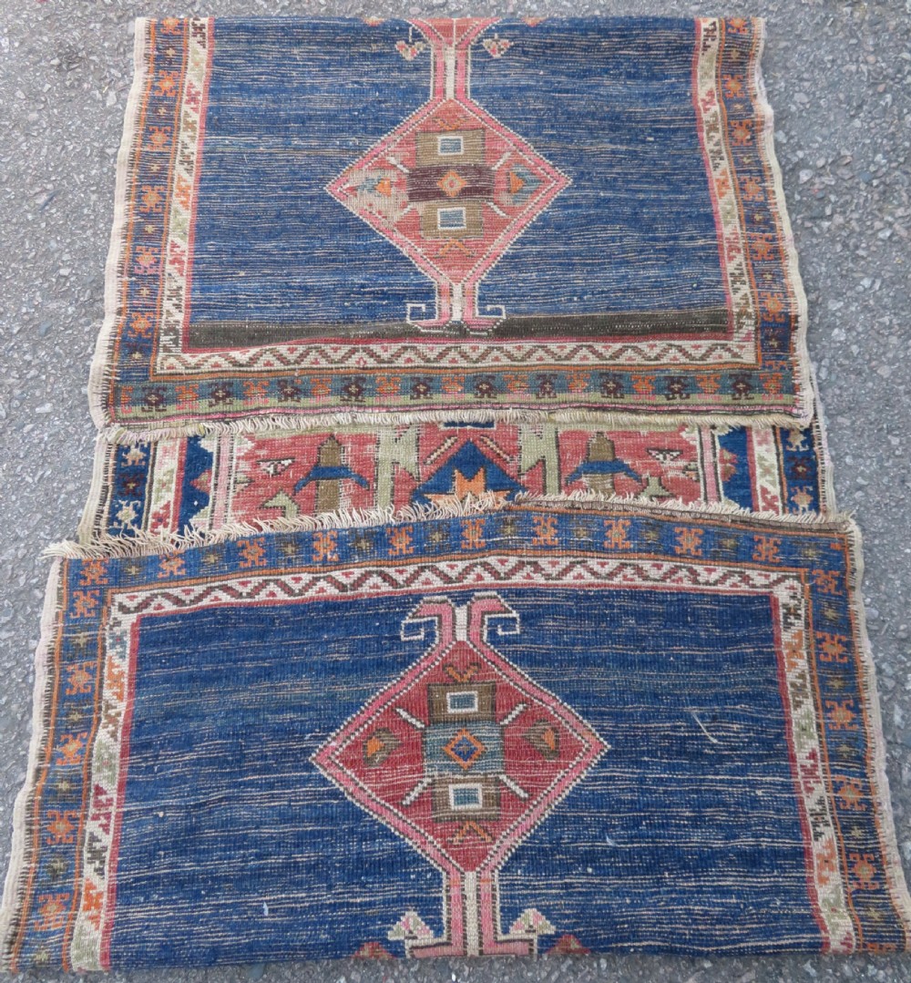An antique hand-woven Turkish runner rug featuring indigo blue ends and a distressed red and cream geometric central medallion pattern. View XVI