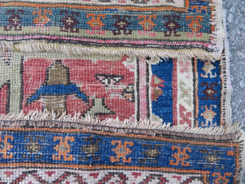 An antique hand-woven Turkish runner rug featuring indigo blue ends and a distressed red and cream geometric central medallion pattern. View XVII