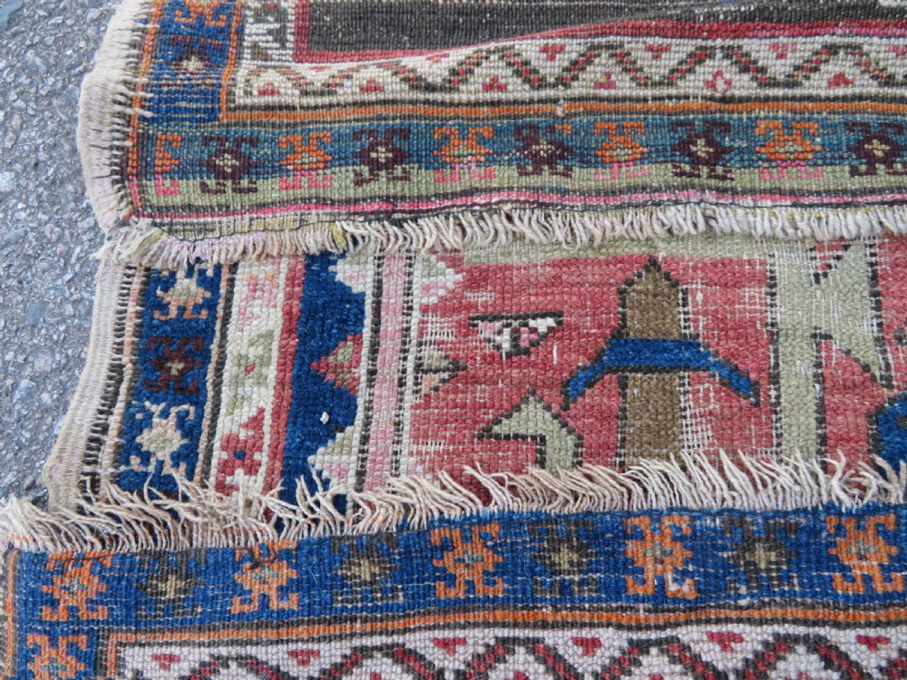 An antique hand-woven Turkish runner rug featuring indigo blue ends and a distressed red and cream geometric central medallion pattern. View XVIII