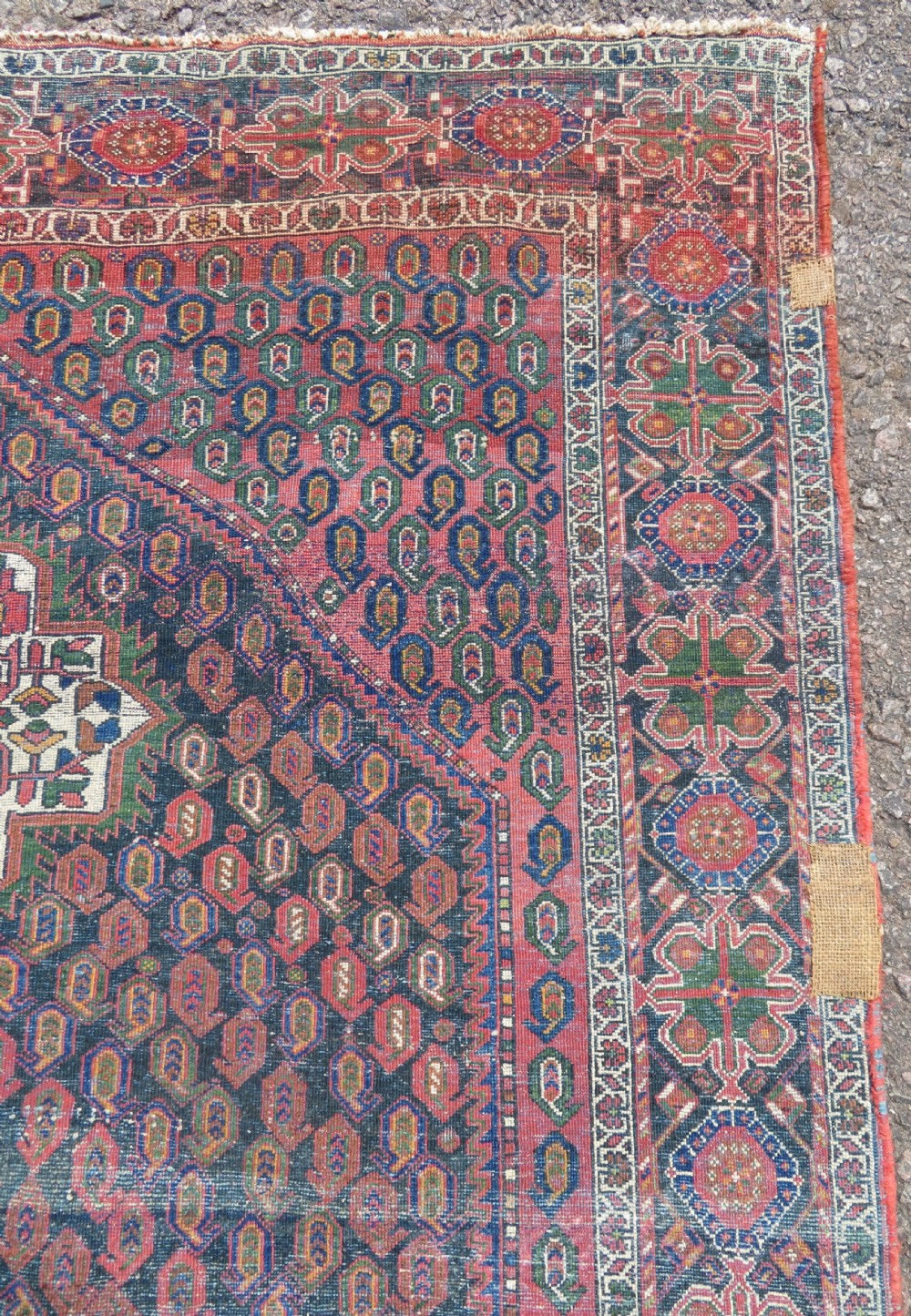 A hand-knotted Bakhtiari tribal wool rug with central ivory and blue medallions framed by a dark navy field with repeating boteh patterns and a detailed geometric border. View XIV