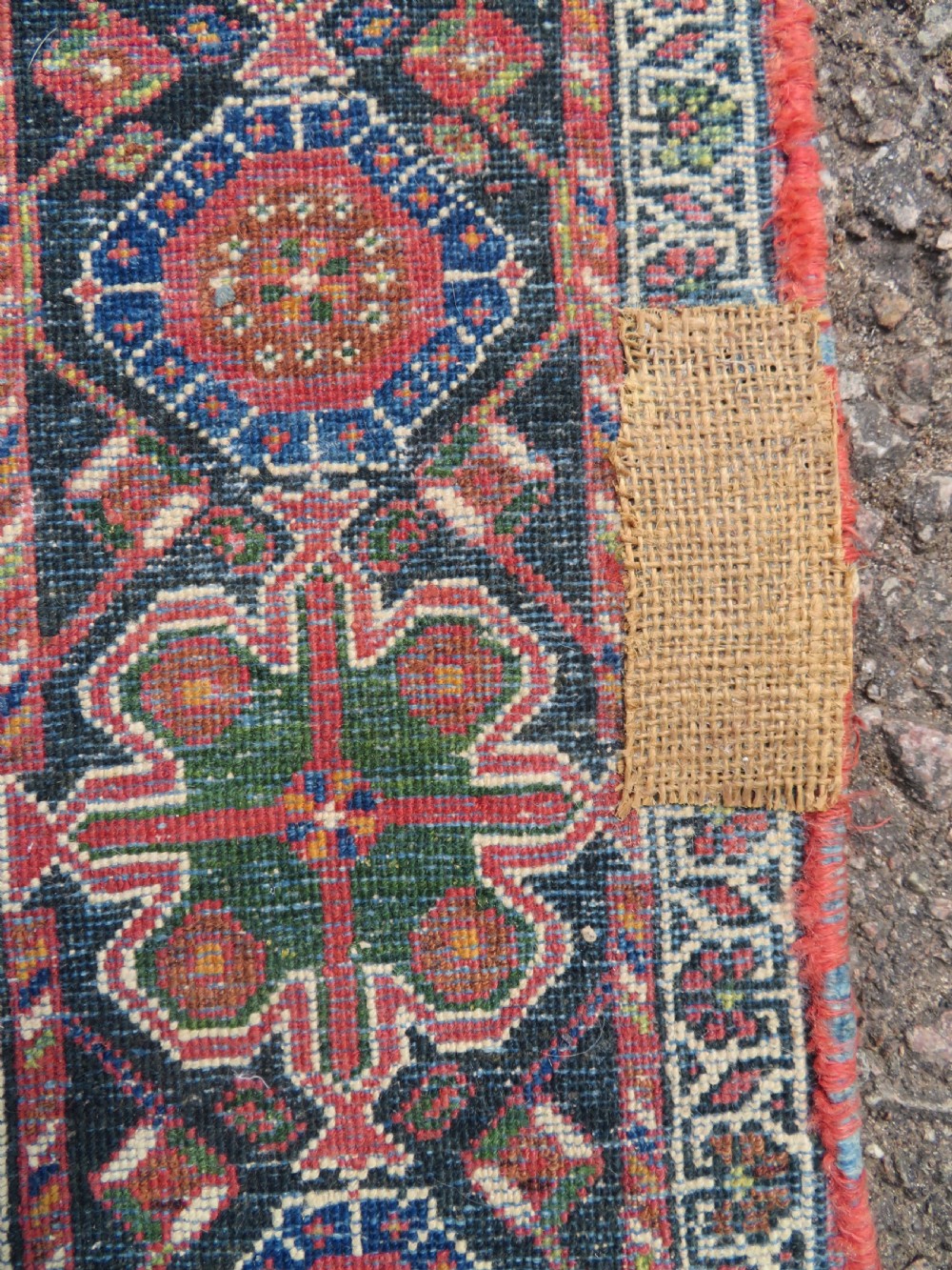 A hand-knotted Bakhtiari tribal wool rug with central ivory and blue medallions framed by a dark navy field with repeating boteh patterns and a detailed geometric border. View XV