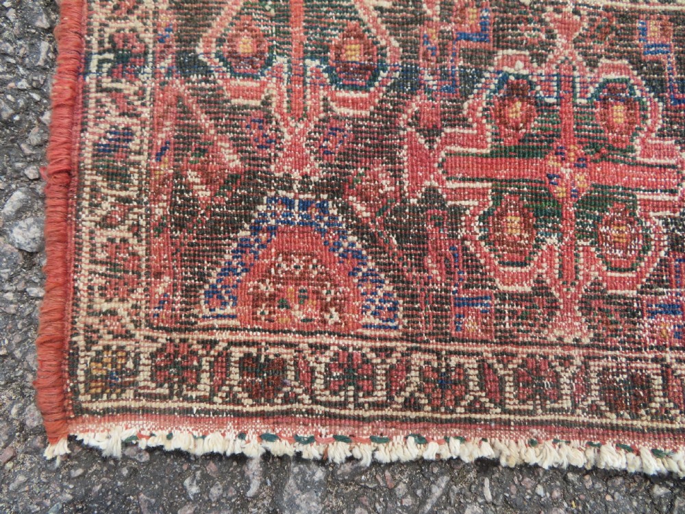 A hand-knotted Bakhtiari tribal wool rug with central ivory and blue medallions framed by a dark navy field with repeating boteh patterns and a detailed geometric border. View XVI