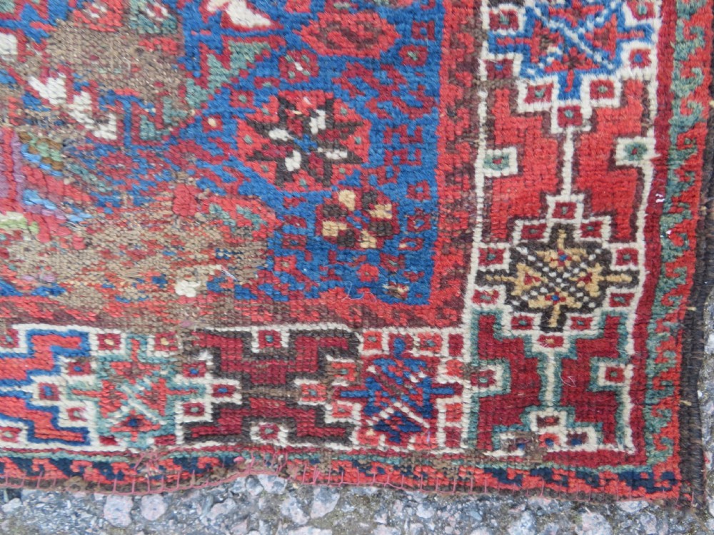 An antique Khamseh hand-knotted wool rug featuring three stacked geometric diamond medallions on an indigo blue field surrounded by intricate patterned borders. View VII