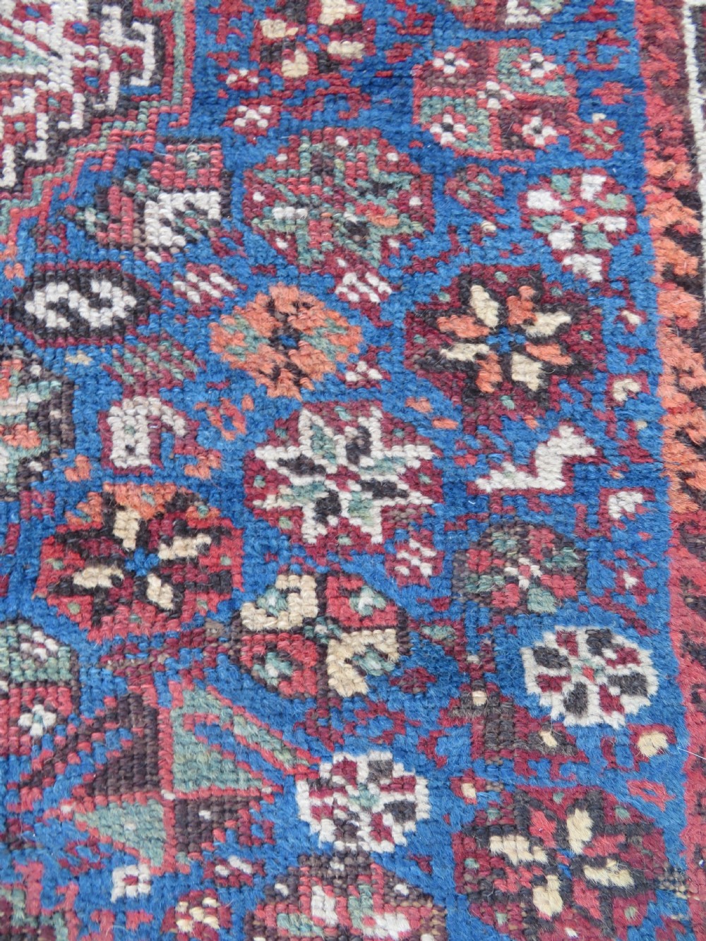 An antique Khamseh hand-knotted wool rug featuring three stacked geometric diamond medallions on an indigo blue field surrounded by intricate patterned borders. View IX