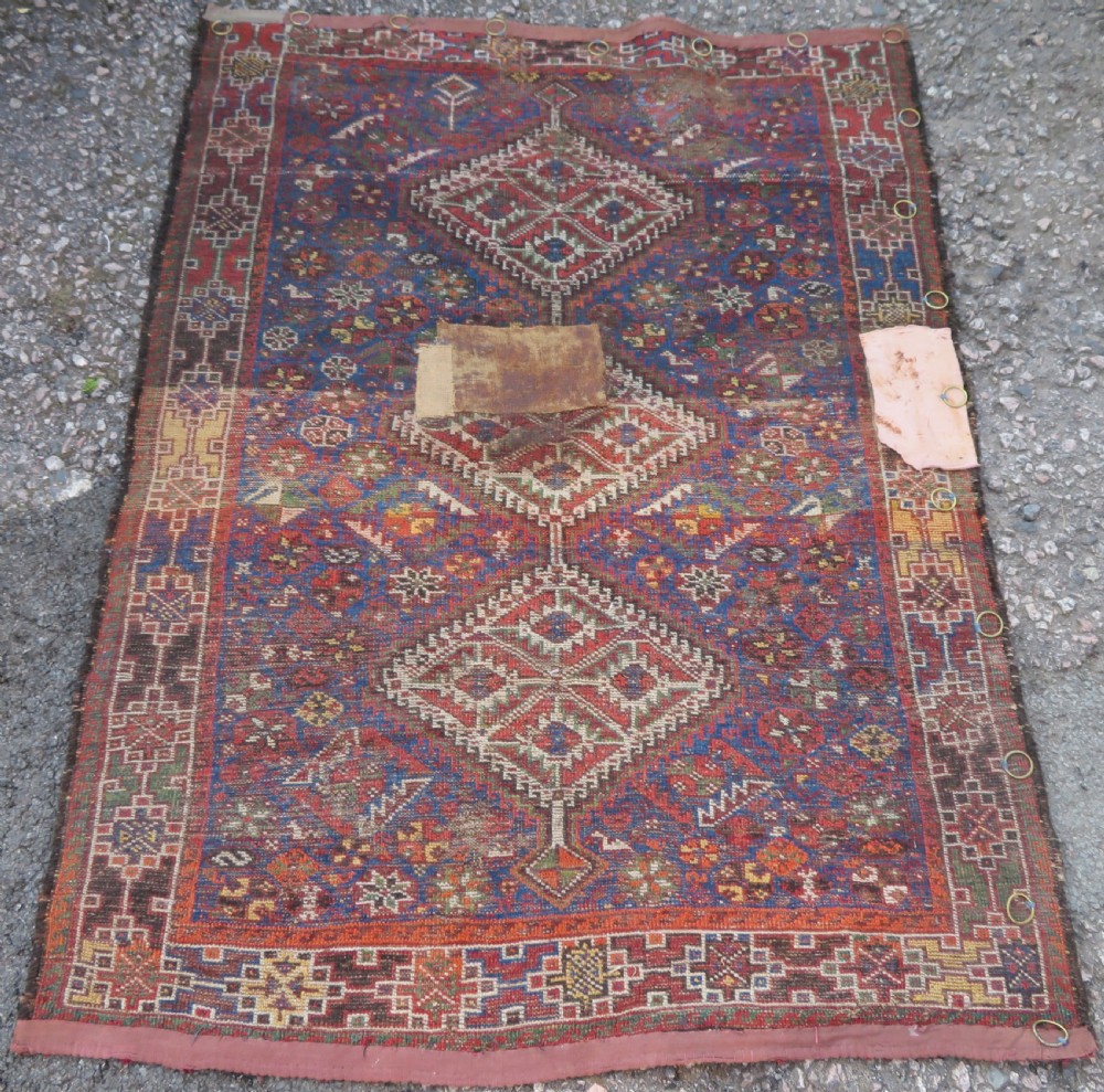An antique Khamseh hand-knotted wool rug featuring three stacked geometric diamond medallions on an indigo blue field surrounded by intricate patterned borders. View XII