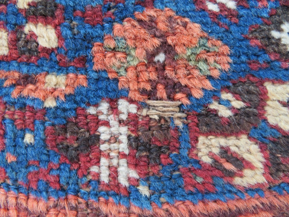 An antique Khamseh hand-knotted wool rug featuring three stacked geometric diamond medallions on an indigo blue field surrounded by intricate patterned borders. View XVII