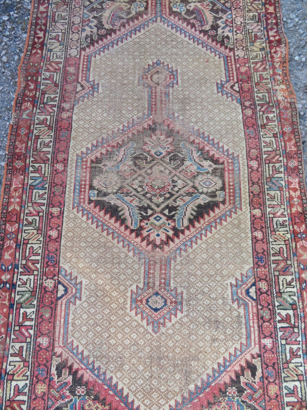 An antique hand-knotted Sarab rug with a geometric central medallion, camel hair field, and distressed terracotta borders. View II