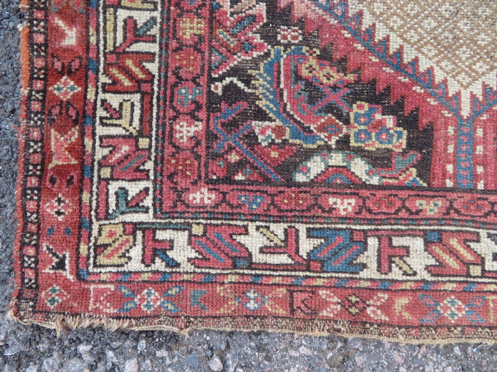 An antique hand-knotted Sarab rug with a geometric central medallion, camel hair field, and distressed terracotta borders. View XI