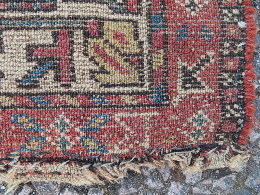An antique hand-knotted Sarab rug with a geometric central medallion, camel hair field, and distressed terracotta borders. View XIV